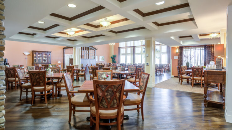 Inviting dining area with warm lighting, comfortable seating, and large windows fostering community spirit.