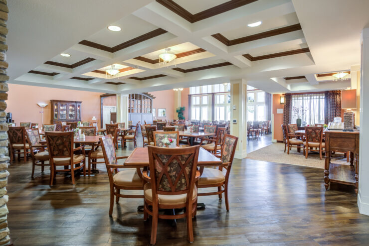 Inviting dining area with warm lighting, comfortable seating, and large windows fostering community spirit.