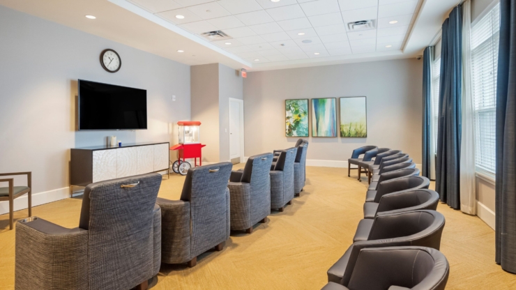 A cozy lounge area invites relaxation, featuring comfortable seating and cheerful decor, fostering community.