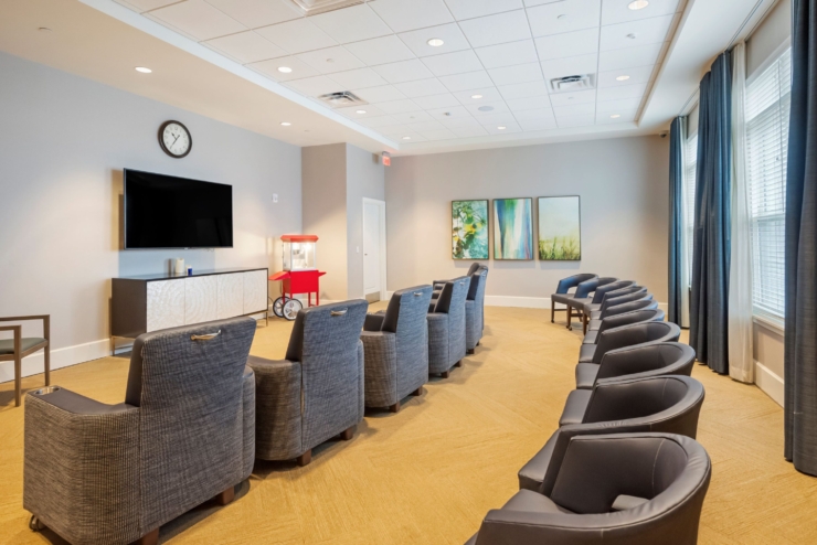 A cozy lounge area invites relaxation, featuring comfortable seating and cheerful decor, fostering community.