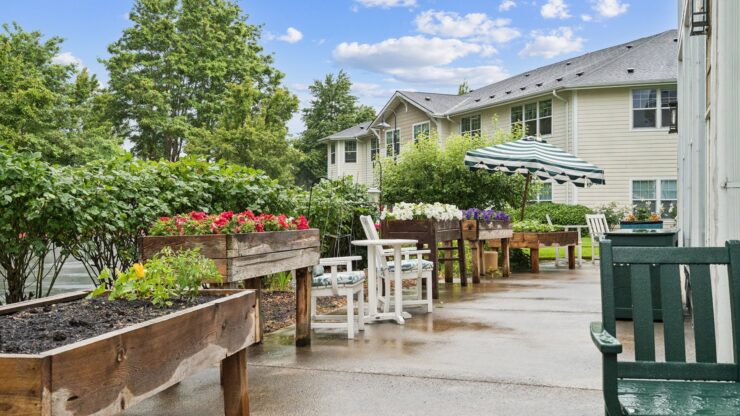 A serene garden setting with vibrant flowers, inviting seating, and a welcoming atmosphere for all.