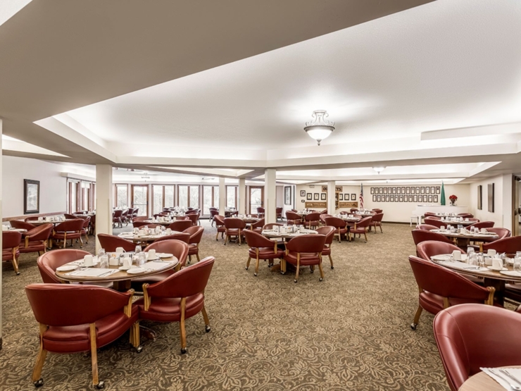 Bright, inviting dining space with warm furnishings, perfect for community meals and connection.