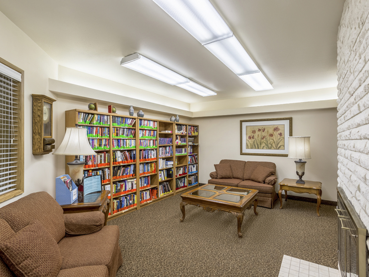A welcoming reading nook filled with colorful books, inviting seating, and warm lighting for relaxation.