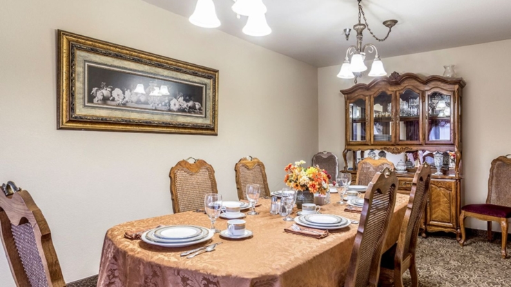 A warm dining area, inviting for community gatherings, features elegant decor and a cozy atmosphere.