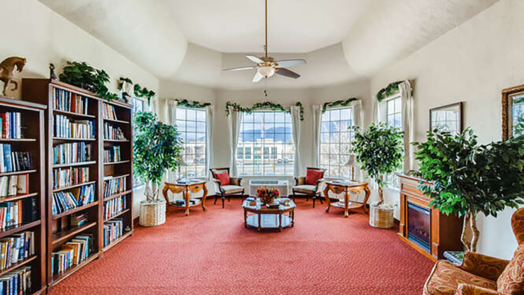 Bright and inviting space with cozy seating, bookshelves, and large windows, fostering community warmth.