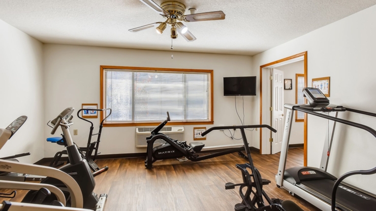 A bright exercise room with modern equipment, fostering a sense of community and wellness.