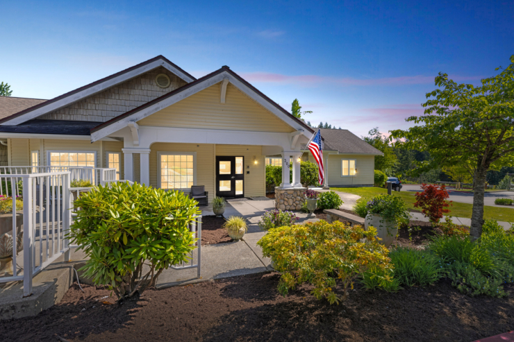 A welcoming entrance with vibrant gardens and a friendly atmosphere, perfect for community living.