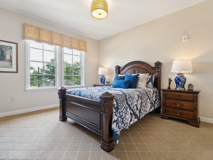 Bright and inviting, this serene bedroom offers a perfect retreat, fostering comfort and community.