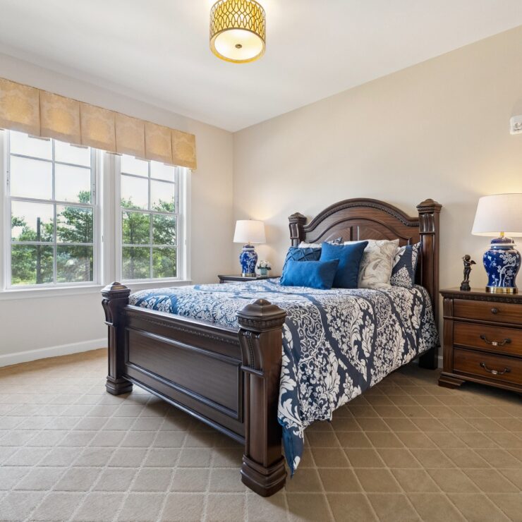 Bright and inviting, this serene bedroom offers a perfect retreat, fostering comfort and community.