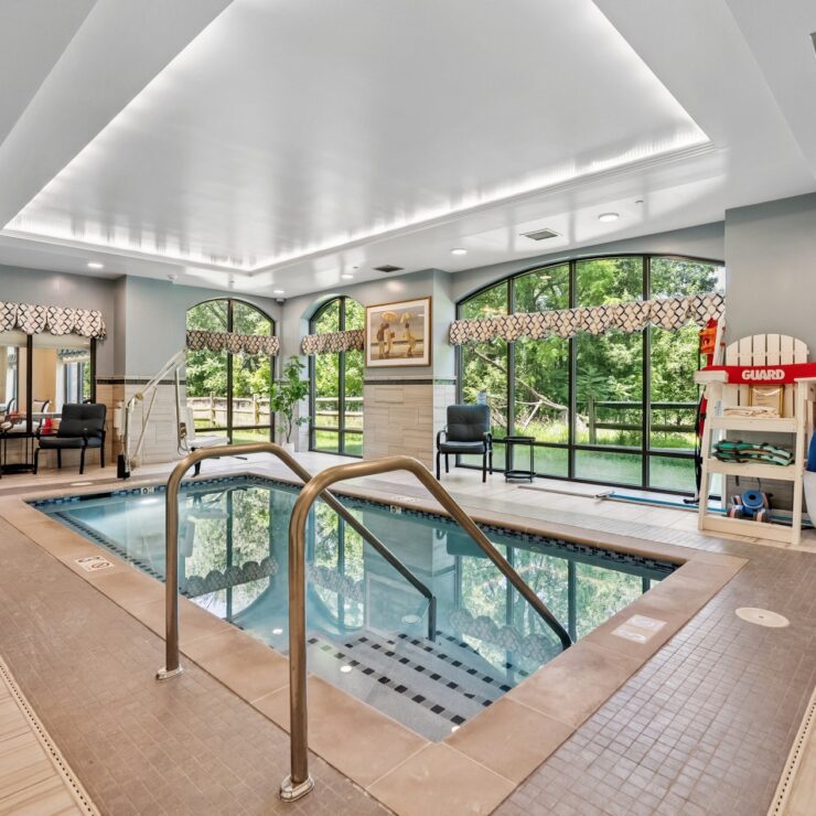 A bright, inviting pool area with large windows, fostering a sense of community and relaxation.