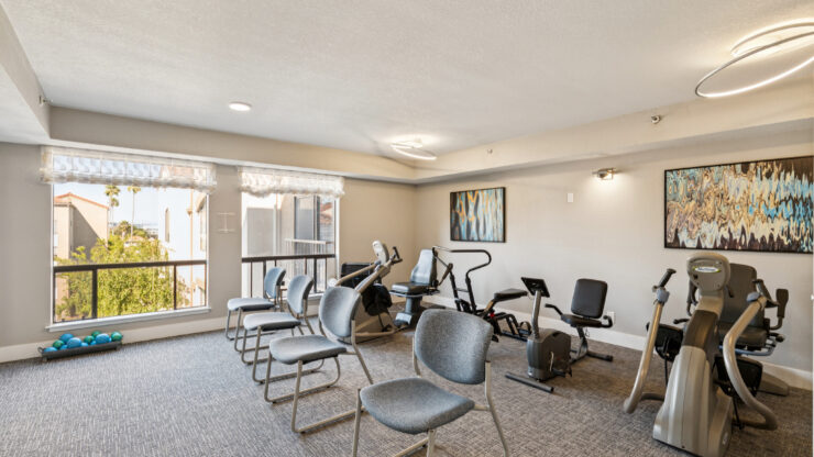 A bright, welcoming fitness area with exercise equipment, promoting health and community engagement.