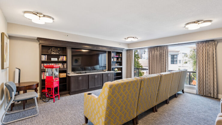 A welcoming lounge with comfortable seating, inviting bookshelves, and bright natural light, perfect for community gatherings.