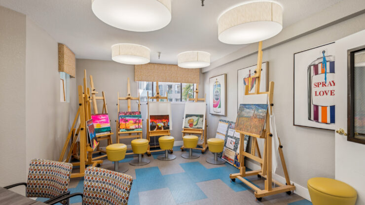 A vibrant art studio filled with easels and colorful creations, fostering creativity and community.