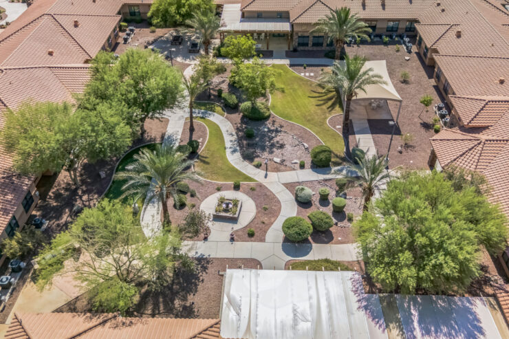 A vibrant garden with winding paths, inviting spaces, and lush greenery fosters community and relaxation.