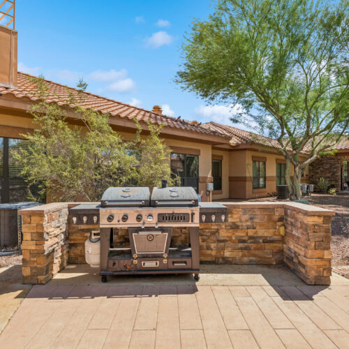 A welcoming outdoor space featuring a barbecue area, perfect for community gatherings and relaxation.