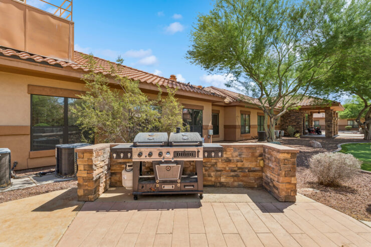 A welcoming outdoor space featuring a barbecue area, perfect for community gatherings and relaxation.