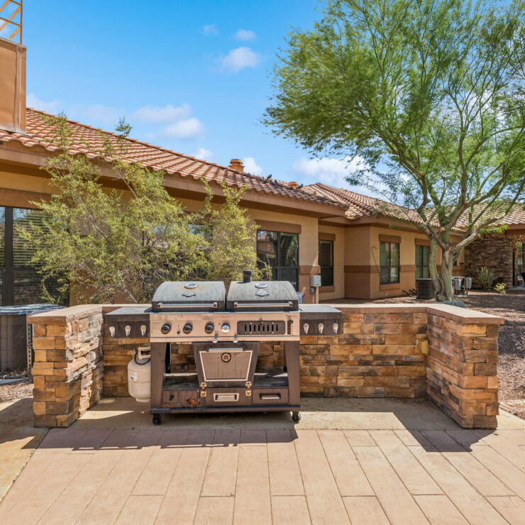 A welcoming outdoor space featuring a barbecue area, perfect for community gatherings and relaxation.