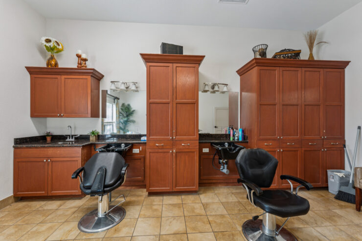 A welcoming salon space with stylish chairs and warm wood cabinetry, perfect for community bonding.
