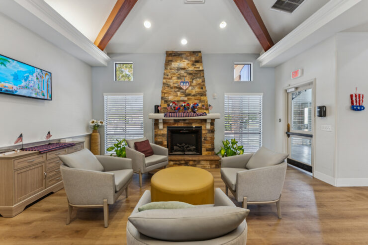 A welcoming lounge area features comfortable seating around a warm fireplace, inviting community and connection.