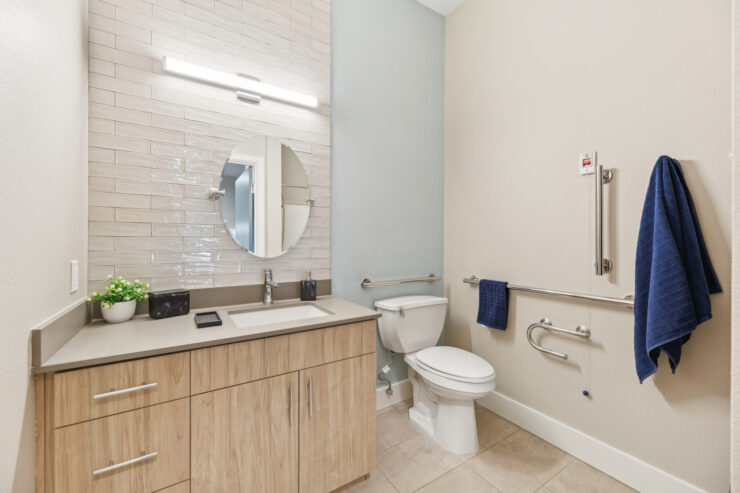 A bright, inviting bathroom featuring modern amenities, promoting comfort and accessibility for all residents.