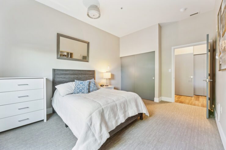 A bright, inviting bedroom designed for comfort, fostering a warm sense of community and relaxation.