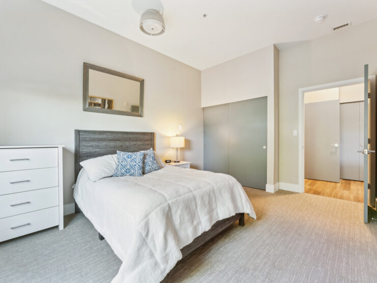 A bright, inviting bedroom designed for comfort, fostering a warm sense of community and relaxation.