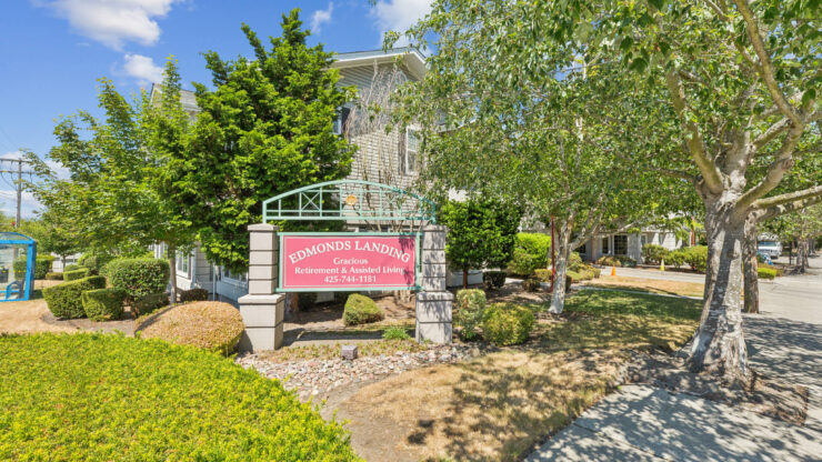 A welcoming entrance surrounded by lush greenery, inviting all to experience community and comfort.