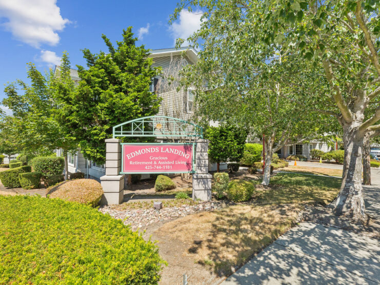 A welcoming entrance surrounded by lush greenery, inviting all to experience community and comfort.