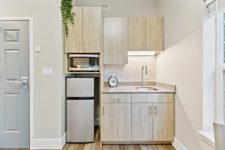 A welcoming kitchenette, featuring modern appliances and natural accents, perfect for community living.