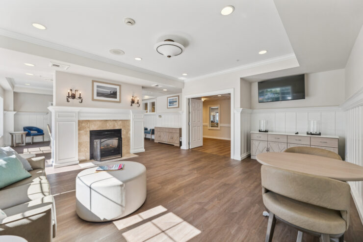 A welcoming lounge featuring warm lighting, comfortable seating, and a fireplace, fostering community and relaxation.