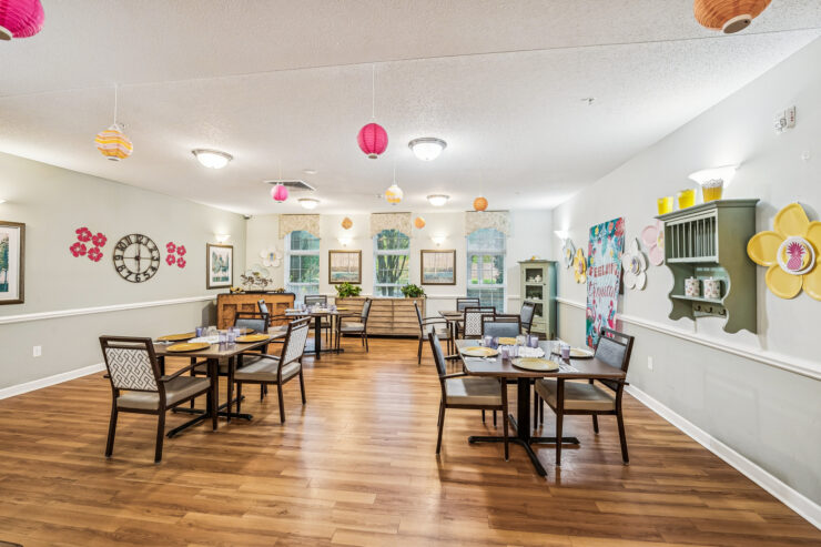 A welcoming dining area filled with light, inviting tables, and vibrant decor for community gatherings.