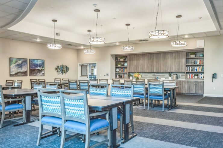 A welcoming dining area with bright lighting and blue-accented furniture, perfect for community gatherings.