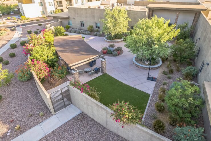 A serene outdoor space with lush greenery, inviting seating, and pathways that encourage community connections.