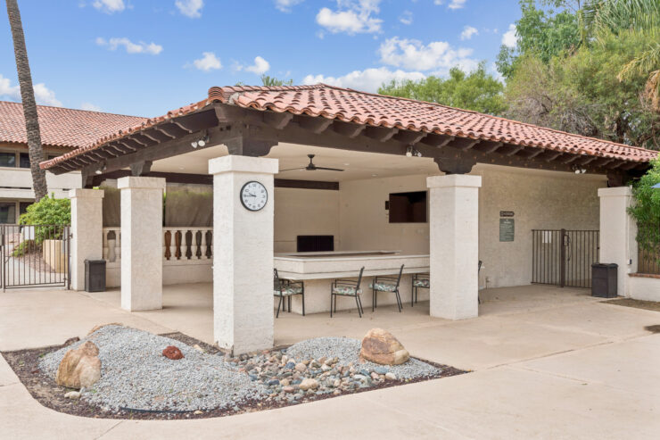 A welcoming outdoor space featuring a shaded area, perfect for gatherings and relaxation.