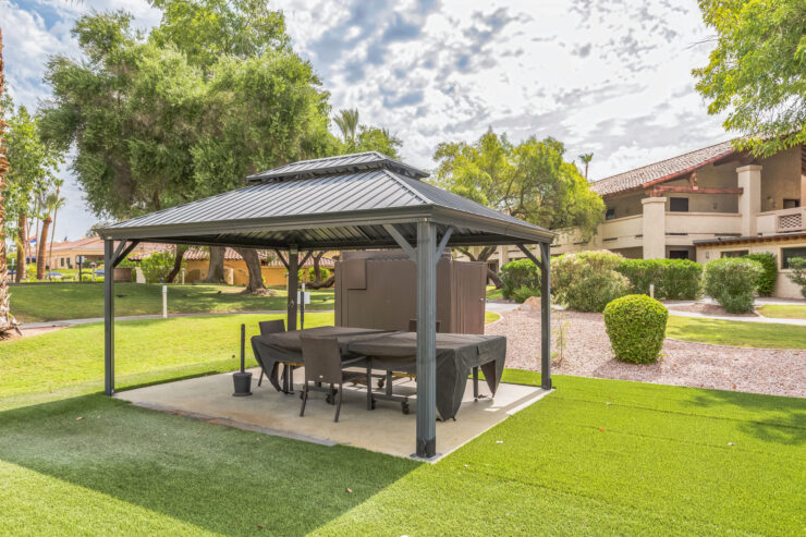 A welcoming gazebo in a serene garden, perfect for gatherings and relaxation among friends.