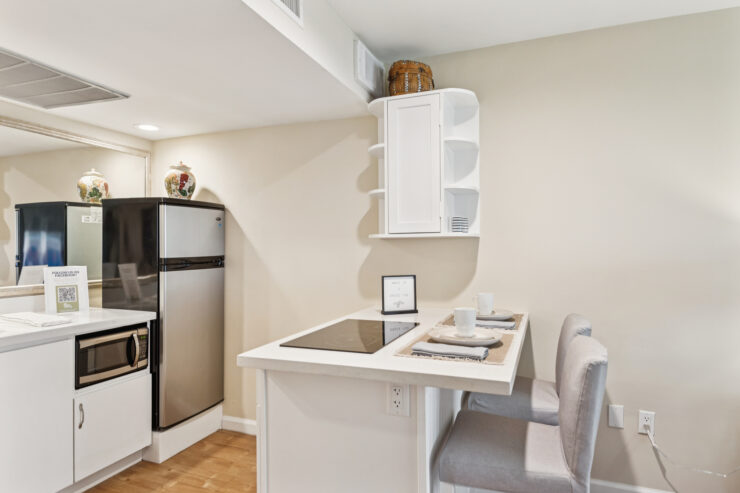 A bright kitchen area with modern appliances and inviting dining space fosters a sense of community and comfort.
