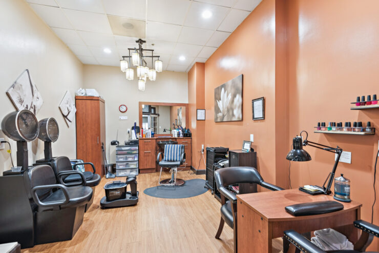 A warm, welcoming salon space designed for relaxation and community engagement.