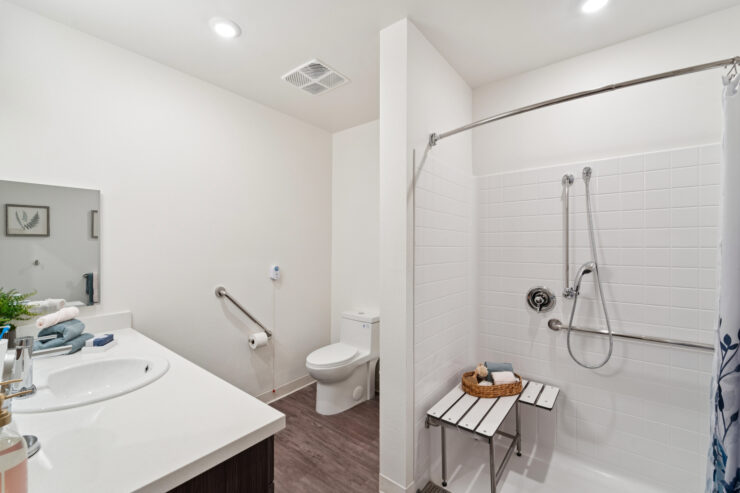 Bright and inviting, this accessible bathroom features modern amenities for comfort and safety.