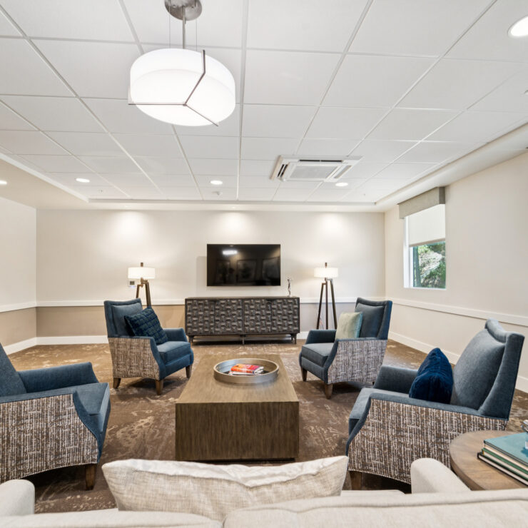A welcoming lounge featuring comfortable seating, warm lighting, and a serene atmosphere for community gatherings.