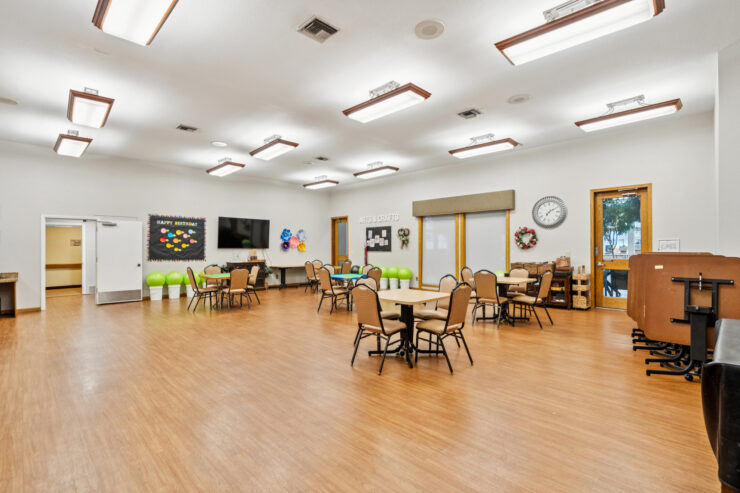 Bright and inviting, this spacious activity room fosters community and connection among residents.