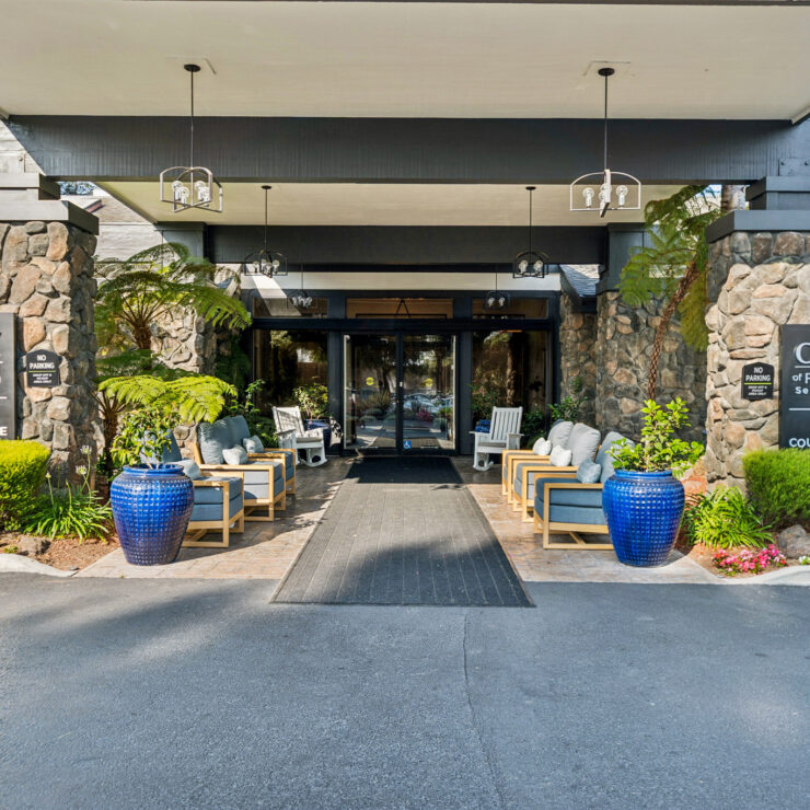 Welcoming entrance with vibrant greenery and comfortable seating, fostering a sense of community.