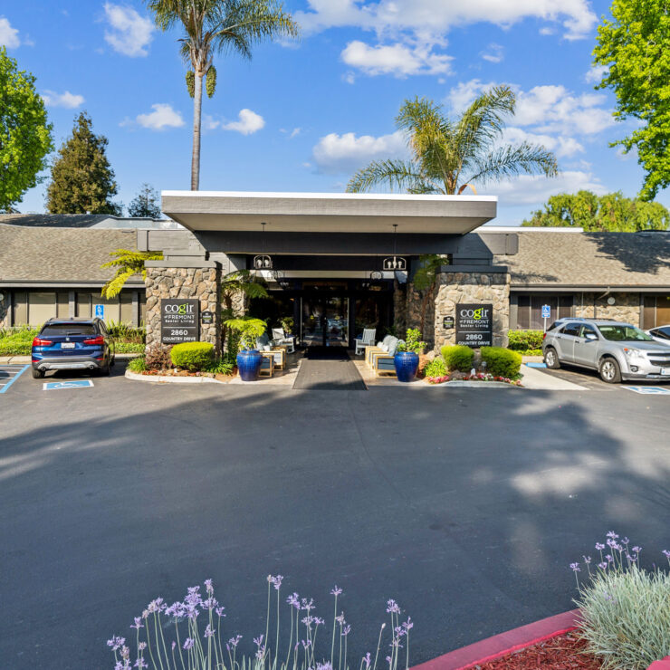 A welcoming entrance surrounded by greenery, inviting community and warmth for all residents.