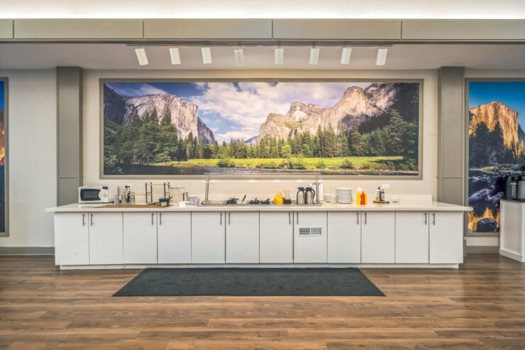 A welcoming kitchen area with a stunning nature mural, fostering a sense of community and warmth.