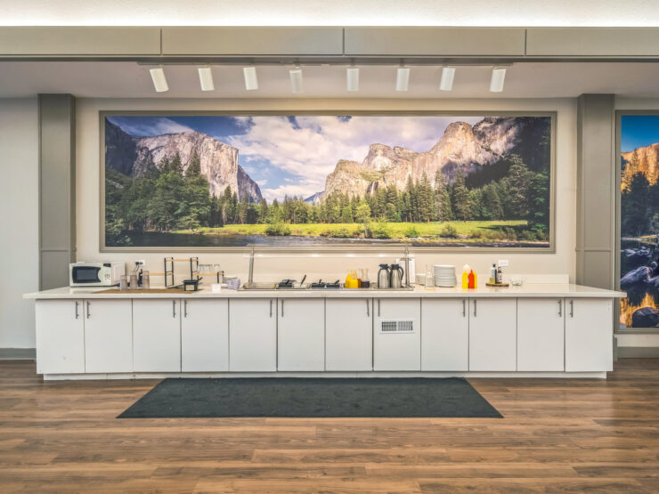 A welcoming kitchen area with a stunning nature mural, fostering a sense of community and warmth.
