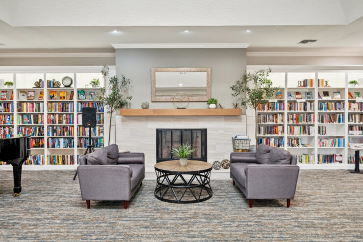 A welcoming lounge invites connection, featuring comfortable seating and a vibrant bookshelf backdrop.