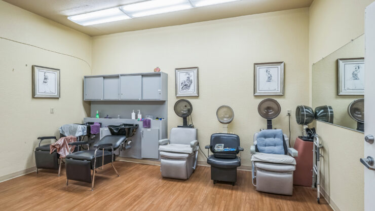 A welcoming salon space, featuring comfortable chairs and vibrant artwork, perfect for community gatherings.
