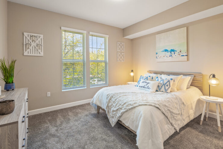 A serene bedroom filled with natural light, inviting comfort and a sense of community.