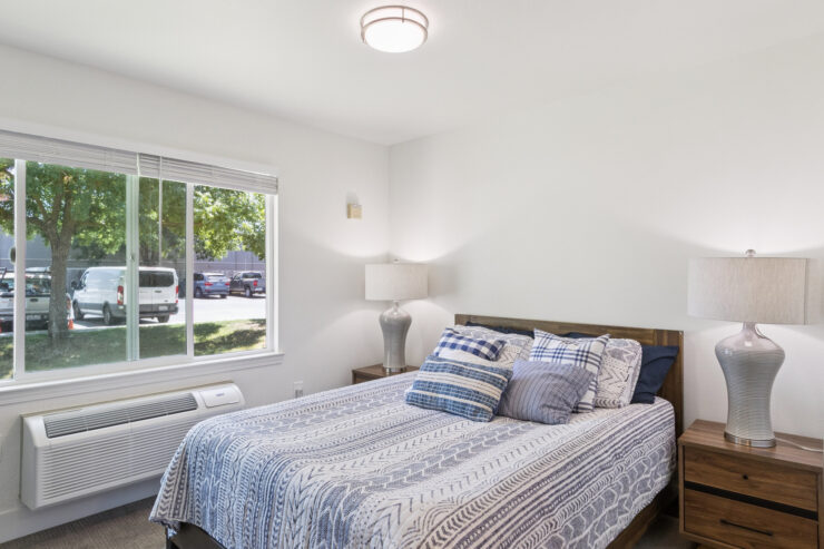 A bright, inviting bedroom with a comfortable bed, natural light, and a serene atmosphere for relaxation.
