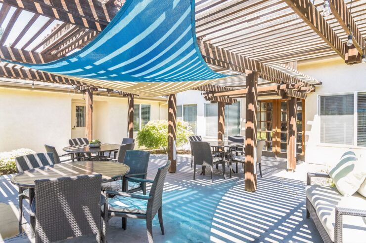 A welcoming outdoor space with shaded seating, perfect for relaxation and community gatherings.