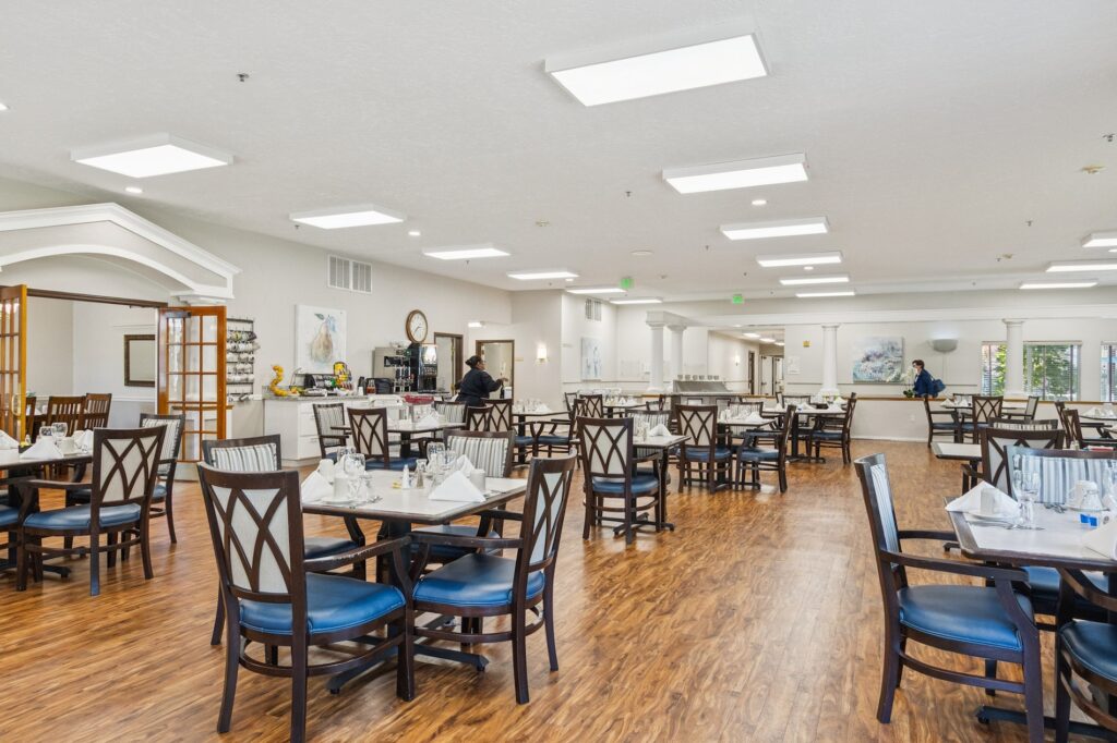 A welcoming dining area filled with light, offering comfortable seating for community gatherings.